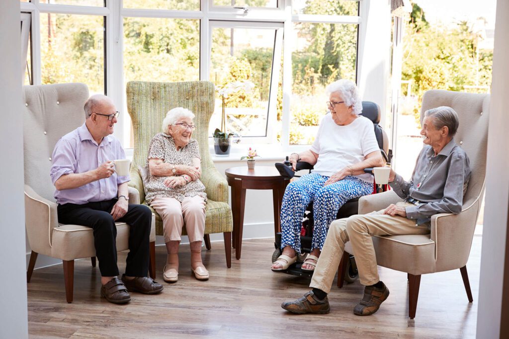 4 elderly woman sit in nice chairs and enjoy a conversation
